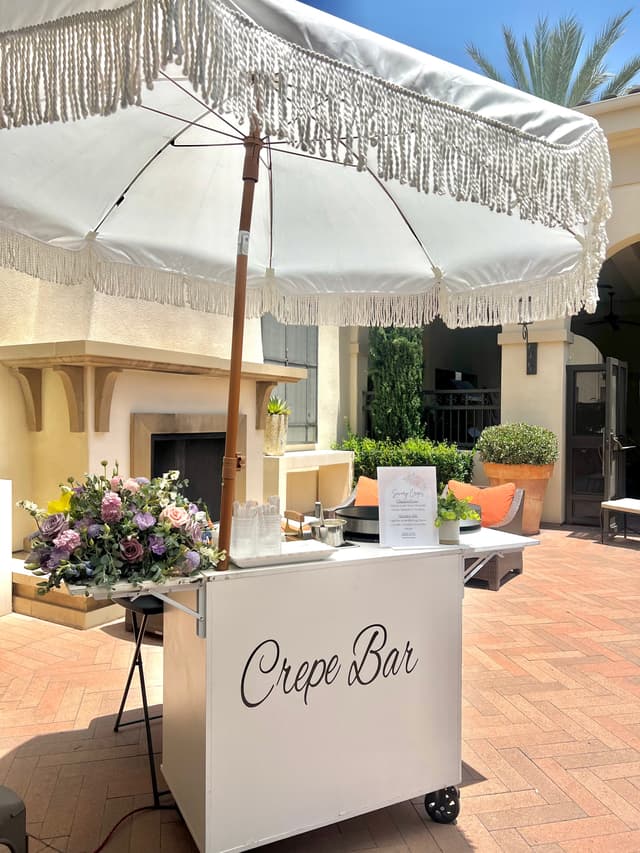 Crepe Bar cart with fringe umbrella at a courtyard event