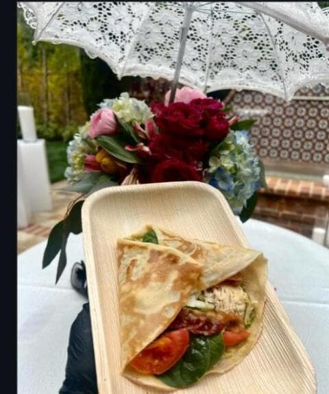 Savory crepe cart under outdoor umbrellas at an event
