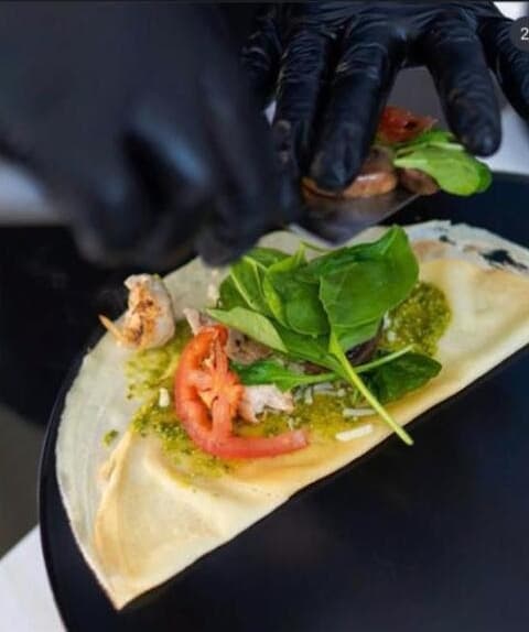 Savory crepe being prepared on the Crepe Lamour cart griddle